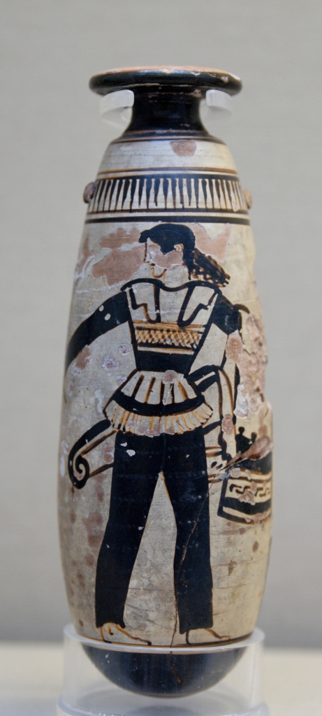 Amazon wearing trousers and carrying a shield with an attached patterned cloth and a quiver. Ancient Greek Attic white-ground alabastron, ca. 470 BC, British Museum, London. Photo Credit: Marie-Lan Nguyen (2007)